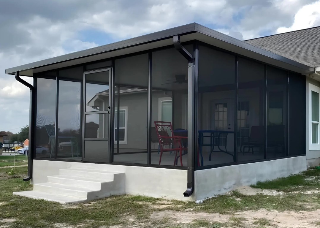 Modern patio enclosure with dark framing and screening